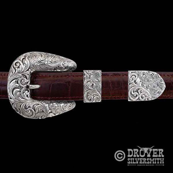 The Lasso Sterling Silver Buckle feautures a fine engraving combination of hand engraved scrollwork that makes for a sophisticated dual tone Western Look. Add a second loop for a ranger buckle set now!
